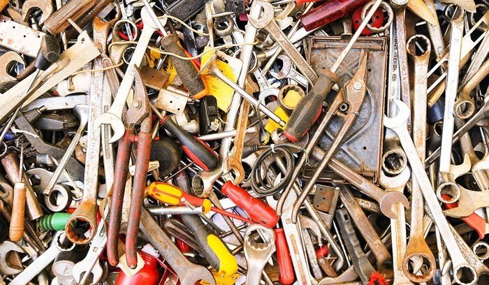 An image of a bunch of different screwdrivers, wrenches, and other tools piled on top of each other.